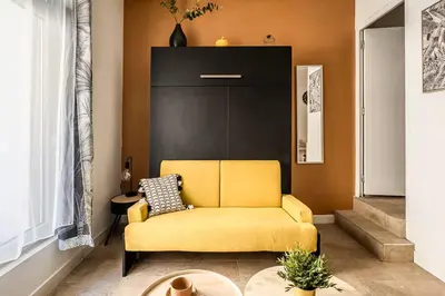 a yellow couch sitting in a living room at Studio narbonne in Narbonne