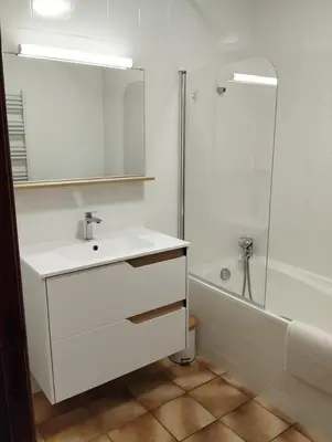 a white bathroom with a sink and a shower at Cheminée, jardin et tranquillité assurée in Verdalle