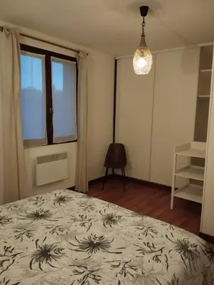 a bedroom with a large bed and a window at Cheminée, jardin et tranquillité assurée in Verdalle