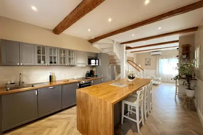 a kitchen with a wooden counter top in a room at Gîte Le Courredou Portel des Corbières in Portel-des-Corbières