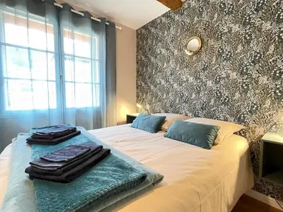 a bedroom with a bed with two towels on it at Gîte Le Courredou Portel des Corbières in Portel-des-Corbières