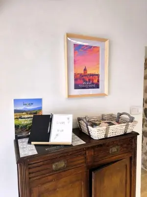a wooden cabinet with a box on top of it at La maison au bord de l'Aude in Limoux
