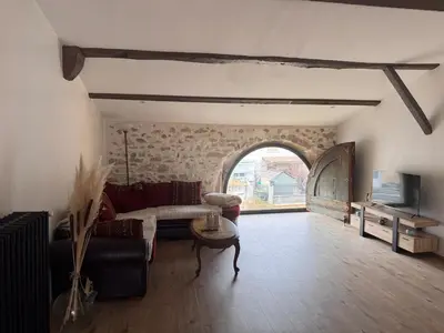 a living room with a couch and a table at La maison au bord de l'Aude in Limoux