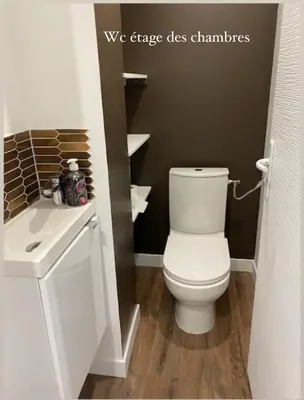 a bathroom with a white toilet and a sink at Le Havre de Paix in Espérausses