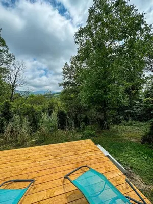 a wooden deck with a view of a field at Le Havre de Paix in Espérausses