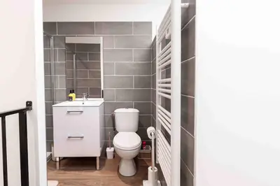 a small bathroom with a toilet and a sink at L'Intime - Cozy & air-conditioned duplex - Near Carcassonne in Pennautier