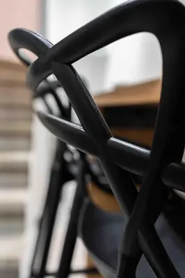 a close up of the back of a black chair at L'Intime - Cozy & air-conditioned duplex - Near Carcassonne in Pennautier
