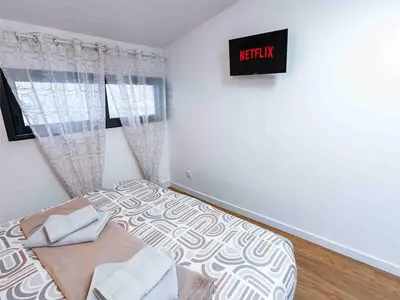 a bedroom with a bed and a sign on the wall at L'Intime - Cozy & air-conditioned duplex - Near Carcassonne in Pennautier