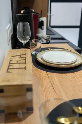 a table with a plate and a wine glass on it at L'Intime - Cozy & air-conditioned duplex - Near Carcassonne in Pennautier