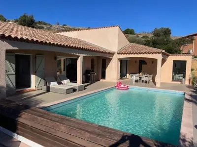 a house with a swimming pool in front of a house at Villa piscine climatisation vue mer pour 8 in Fitou