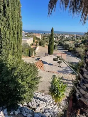 a view of a garden with trees and plants at Villa piscine climatisation vue mer pour 8 in Fitou