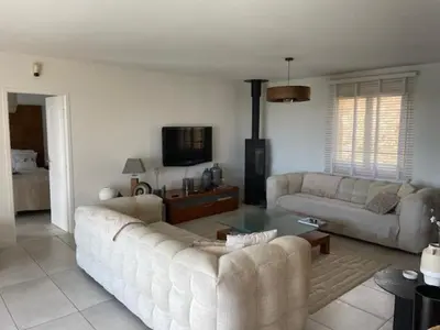 a living room with two couches and a tv at Villa piscine climatisation vue mer pour 8 in Fitou
