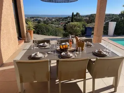 a table with plates of food on it on a patio at Villa piscine climatisation vue mer pour 8 in Fitou
