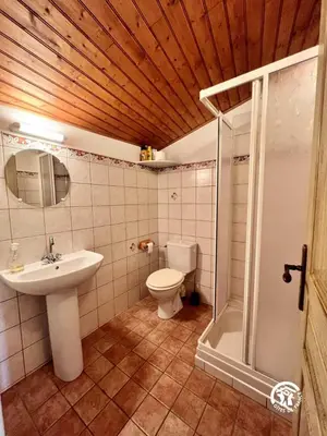 a bathroom with a toilet and a sink and a shower at Domaine de la calm in Villardonnel