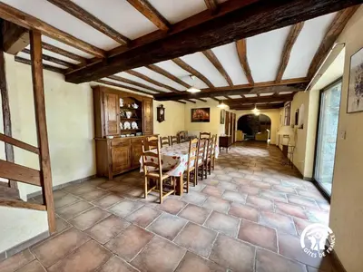 a kitchen and dining room with a table and chairs at Domaine de la calm in Villardonnel