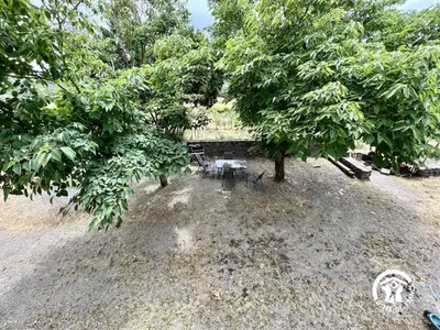 a picnic table and chairs under two trees at La calm in Villardonnel