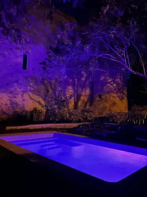 a swimming pool at night with purple lighting at Soupex Castle century XII in Soupex