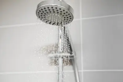 a shower with water coming out of it at 514 Appart Hotel in Carcassonne
