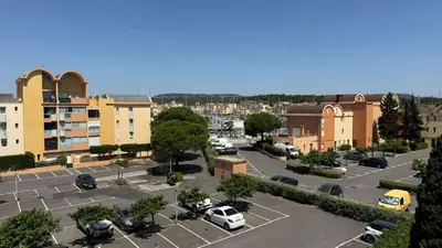 an aerial view of a parking lot in a city at AIG168 GRUISSAN STUDIO VUE PORT AVEC TERRASSE PARKING ET PISCINES in Gruissan