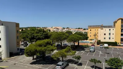 an aerial view of a parking lot in a city at AIG168 GRUISSAN STUDIO VUE PORT AVEC TERRASSE PARKING ET PISCINES in Gruissan
