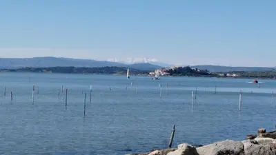 a large body of water with poles in it at Maison avec beaucoup de caractères in Bages