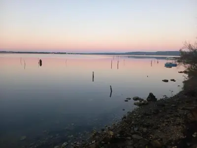 a view of a large body of water at sunset at Maison avec beaucoup de caractères in Bages