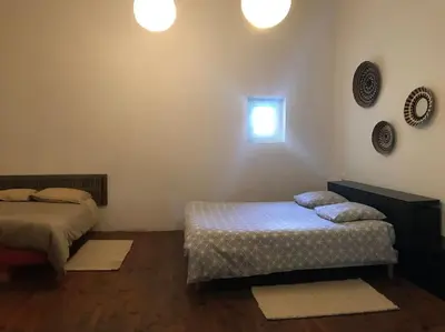 a bedroom with two beds and a window at Gîte Narbonne 15 personnes in Narbonne