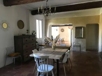 a dining room with a wooden table and chairs at Gîte Narbonne 15 personnes in Narbonne