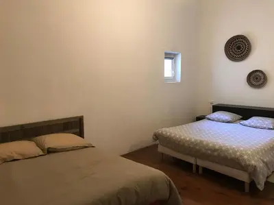 a bedroom with two beds and a window at Gîte Narbonne 15 personnes in Narbonne