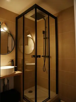 a glass shower in a bathroom with a sink at Studio chaleureux en bord de mer in Gruissan