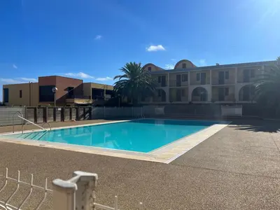 a large swimming pool in front of a building at Studio chaleureux en bord de mer in Gruissan