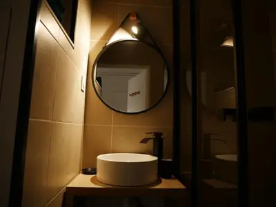 a bathroom with a sink and a mirror at Studio chaleureux en bord de mer in Gruissan