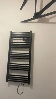 a metal shelf on a wall in a room at Résidence des catalans in Narbonne