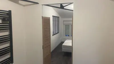 a room with a bed and a mirror at Résidence des catalans in Narbonne