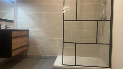 a bathroom with a shower with a glass case at Résidence des catalans in Narbonne