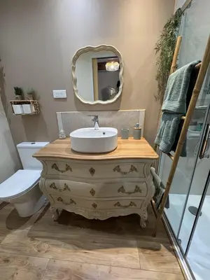 a bathroom with a sink and a mirror at L'écrin vert in Villelongue-dʼAude