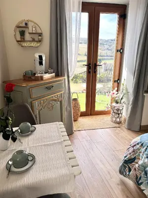 a room with a table and a door with a view at L'écrin vert in Villelongue-dʼAude