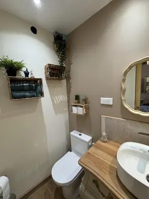 a bathroom with a toilet and a sink and a mirror at L'écrin vert in Villelongue-dʼAude