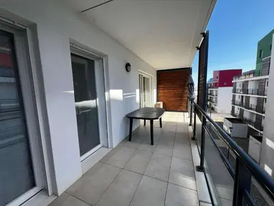 a balcony with a table on a building at AIG 84 – Appartement T3 – Résidence Ephyra – Gruissan – 4 personnes in Gruissan