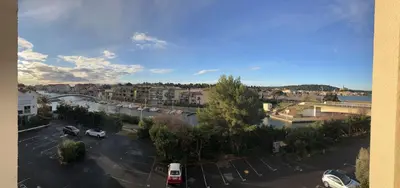 an aerial view of a parking lot in a city at AIG_183 Studio rénové avec terrasse et vue exceptionnelle sur la marina, l’étang et le village de Gruissan in Gruissan