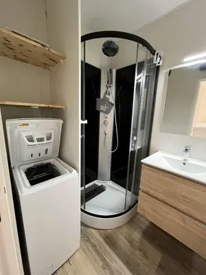 a shower in a bathroom with a sink and a washer at AIG_183 Studio rénové avec terrasse et vue exceptionnelle sur la marina, l’étang et le village de Gruissan in Gruissan
