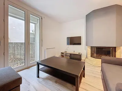 a living room with a coffee table and a fireplace at Le Garibaldi - Appartement proche du centre - Wi-Fi in Narbonne