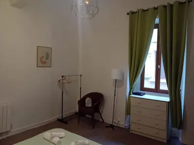 a room with a desk and a chair and a window at Le Damier in Quillan