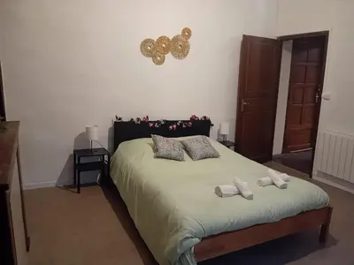 a bedroom with a bed with two towels on it at Le Damier in Quillan