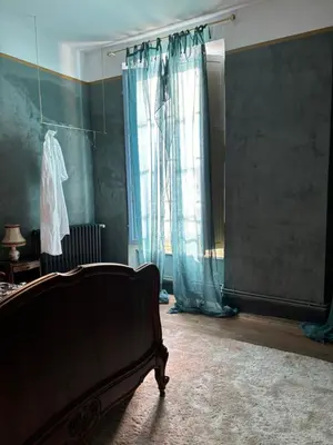 a living room with a bed and a window at La Maison Jolie bnb in Puicheric