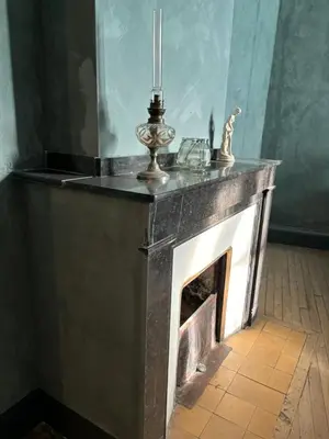 a fireplace with a candle on top of it at La Maison Jolie bnb in Puicheric