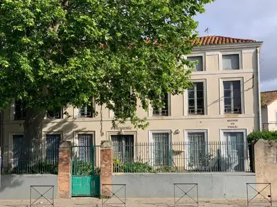 a building with a tree in front of it at La Maison Jolie bnb in Puicheric