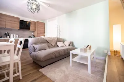 a living room with a couch and a table at Duplex cosy à Mirepoix centre, tout confort in Mirepoix