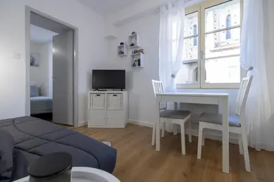 a living room with a table and a couch at 2 appartements cosys en plein cœur de Varilhes in Varilhes