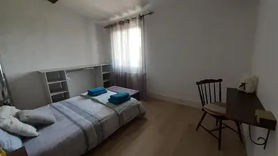 a bedroom with a bed and a table and a desk at Les chambres de Guillaunas Haut in Saint-Germain-des-Prés